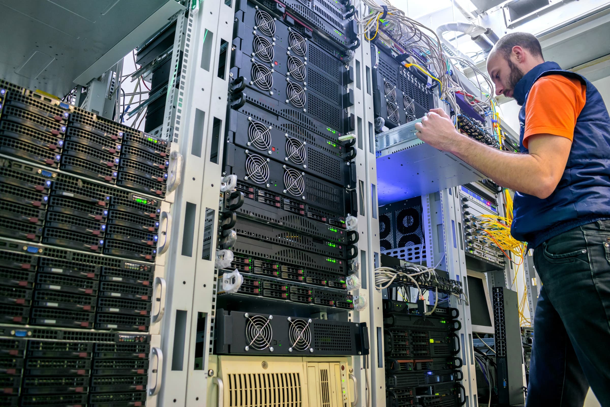 A technician pulling a server from a rack in a data center